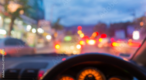 blur image of inside cars with bokeh lights with traffic jam on