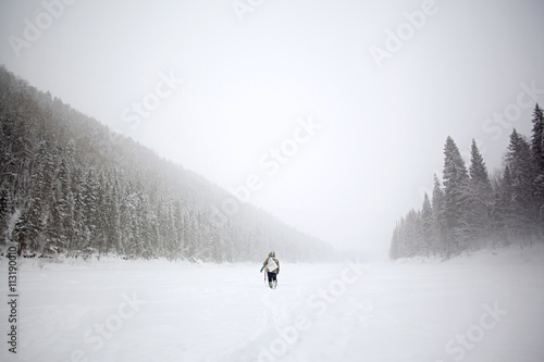 Ice fisherman walking in snow photo