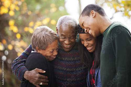 Grandparent and grandchildren hugging and laughing