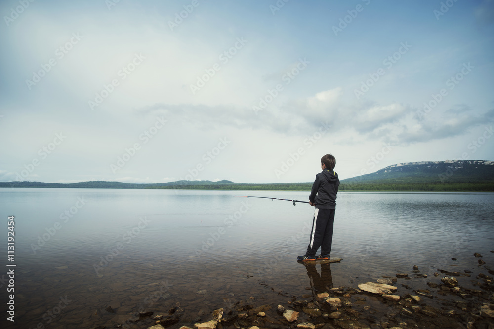 Boy fishing in lake Boy fishing in lake