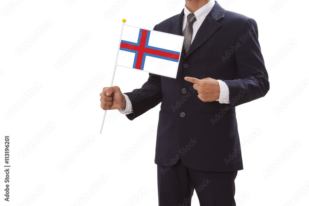 Businessman in suit holding Faroe Islands Flag Businessman in suit holding Faroe Islands Flag