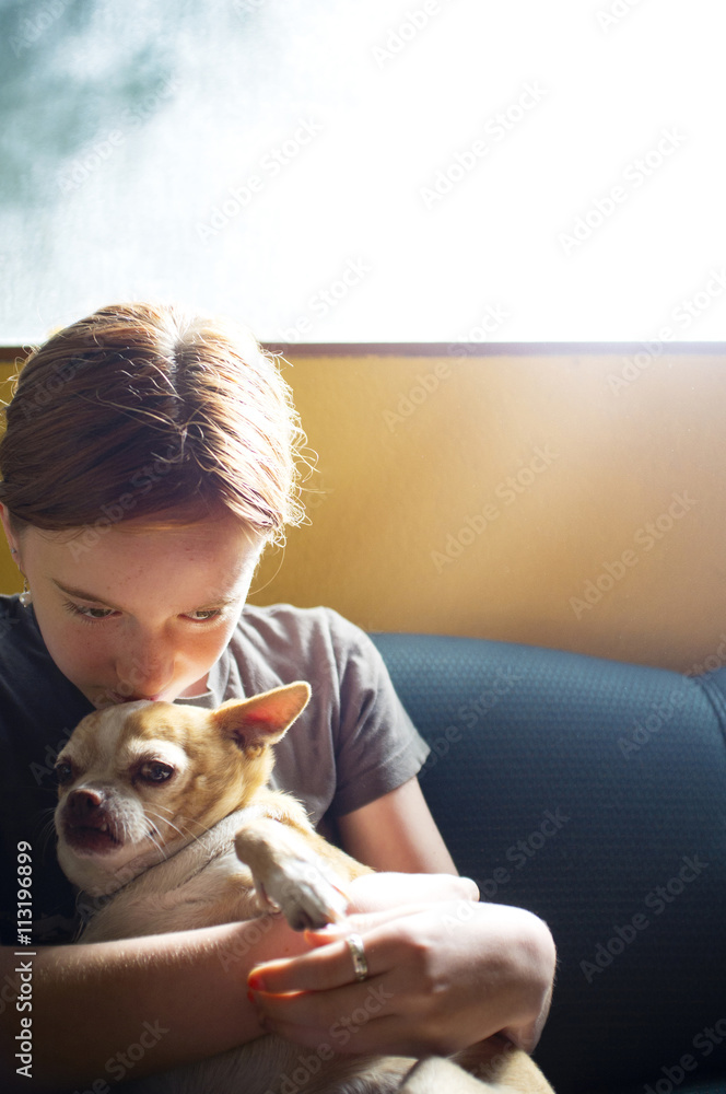 Girl (10-11) kissing and embracing dog Girl (10-11) kissing and embracing dog