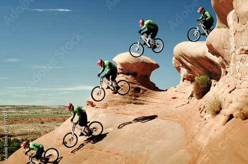 Sequence of downhill biker jumping ledge