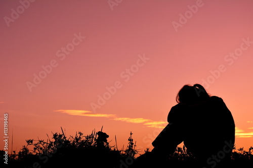 Silhouette sad girl at sunset. © sawitreelyaon