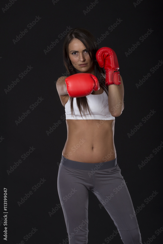 Beautiful long dark hair kick box girl with red gloves on her hands Beautiful long dark hair kick box girl with red gloves on her hands
