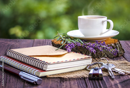 blank white notebook,the keys, bunch of lavender and cup of coff