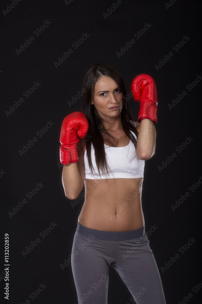 Kick box long dark hair beautiful girl with red gloves on her hands