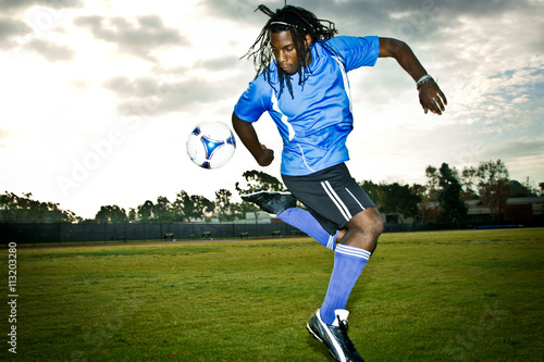 Soccer player practicing rainbow flick on field
