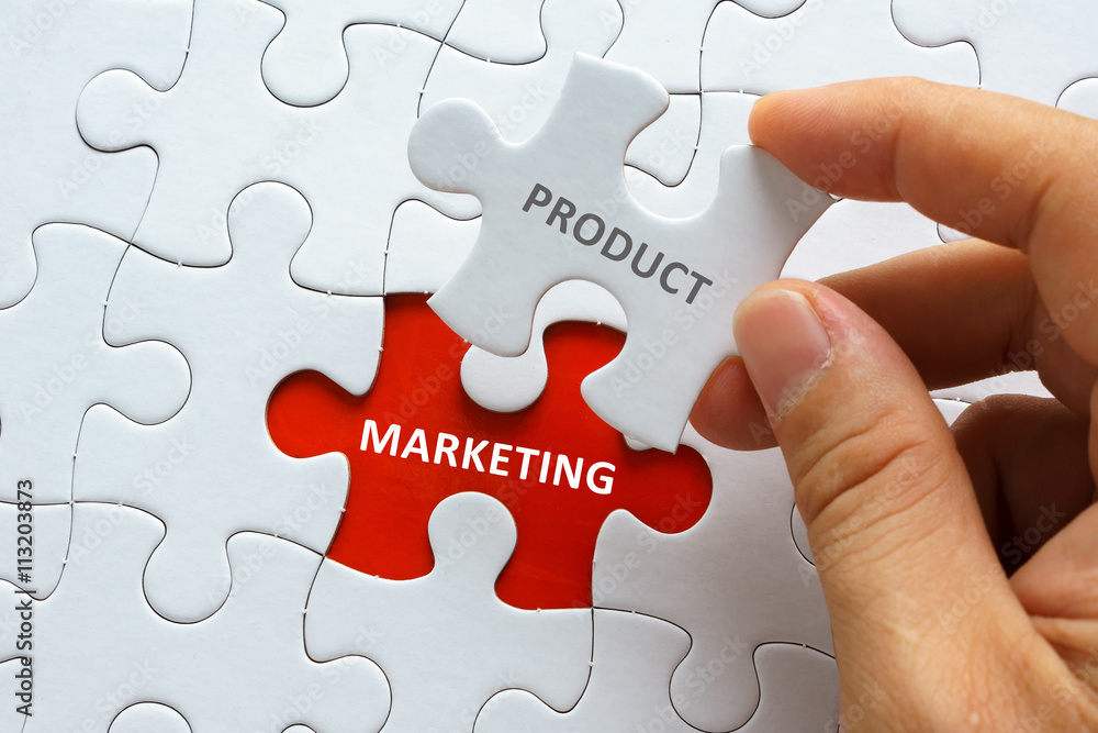 Hand holding piece of jigsaw puzzle with word PRODUCT MARKETING. Hand holding piece of jigsaw puzzle with word PRODUCT MARKETING.