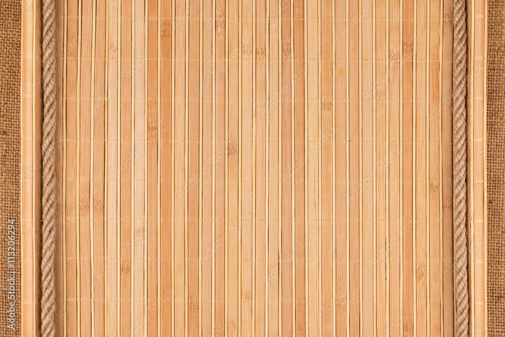 Bamboo mat twisted in the form of a manuscript and rope on sackcloth Bamboo mat twisted in the form of a manuscript and rope on sackcloth