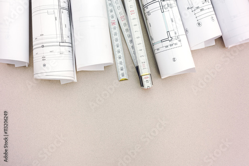 rolls of architecture blueprints and plan with folding rule on d