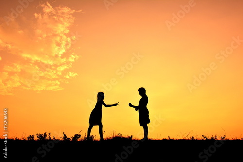 Silhouette children playing rock paper scisors
