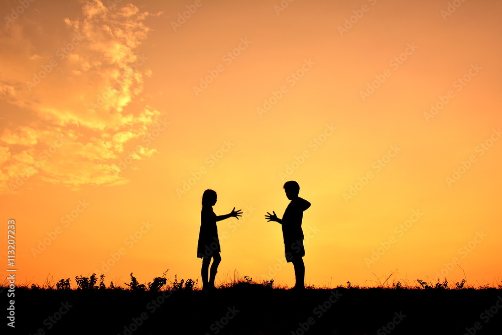 Silhouette children playing rock paper scisors