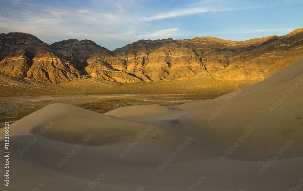 Late afternoon light and colour on the rocks on the last chance mountains rising above Eureka Dunes, Death Valley National Park, California, United States