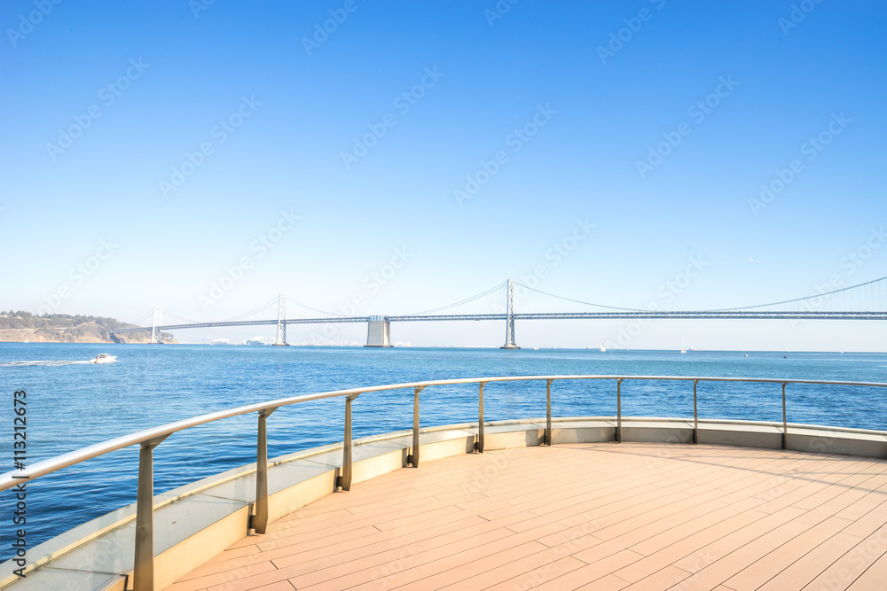 ay bridge over tranquil water in blue sky with brick floor