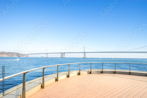ay bridge over tranquil water in blue sky with brick floor