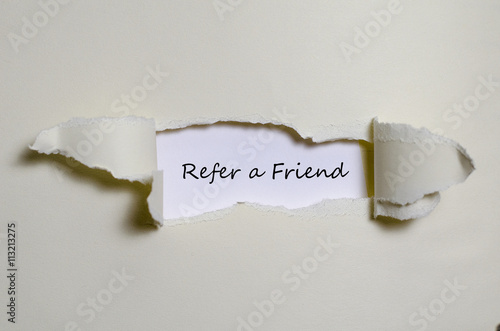 The word refer a friend appearing behind torn paper.
