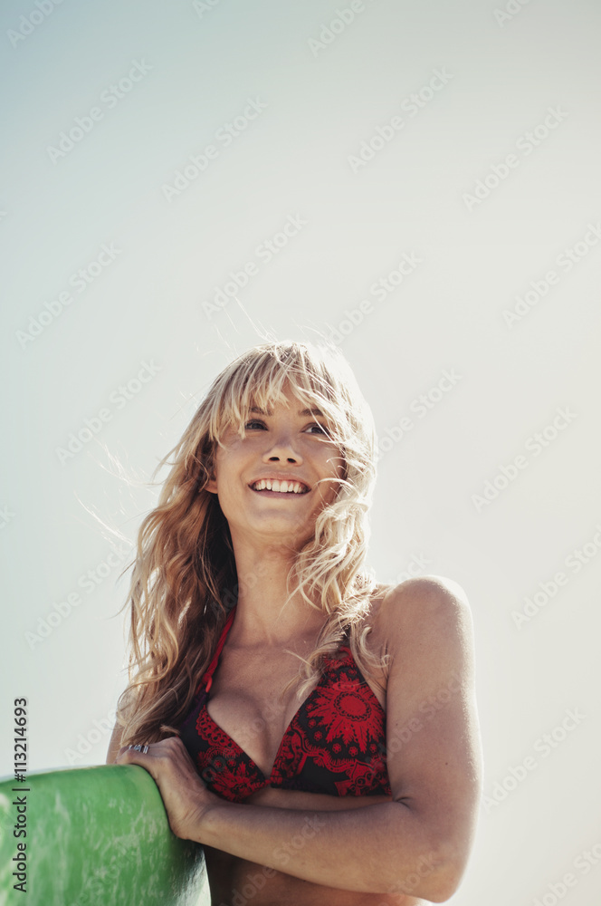 Young woman holding surfboard Young woman holding surfboard