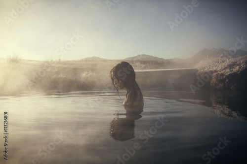 Woman bathing in hot spring photo