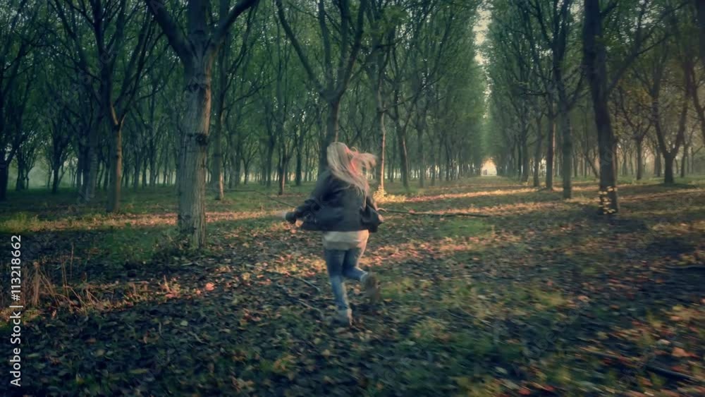 scared afraid female woman runs away escape from murderer chasing her through a dark forest full of trees looking for help horror scene