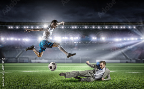 Businessman and player fighting for ball © Sergey Nivens