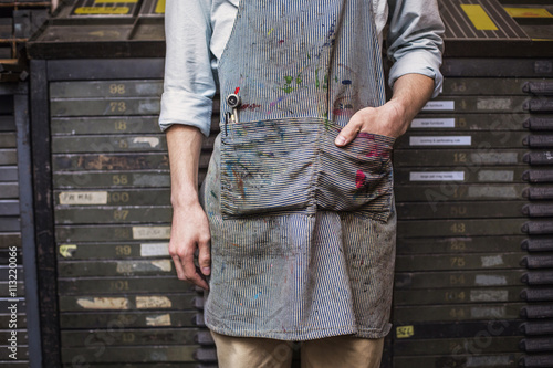 Midsection of worker with dirty apron photo