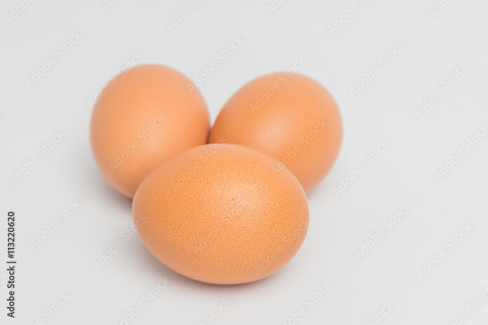 three eggs on white background,three eggs on fabric background, closeup three eggs three eggs on white background,three eggs on fabric background, closeup three eggs
