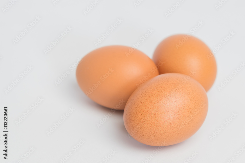 three eggs on white background,three eggs on fabric background, closeup three eggs three eggs on white background,three eggs on fabric background, closeup three eggs