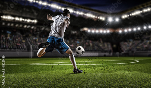 Soccer player hitting ball © Sergey Nivens