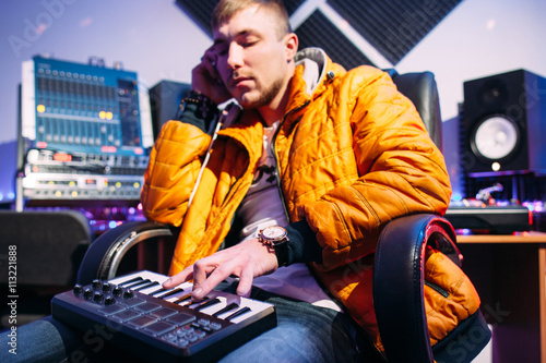 Photography Musician playing on synthesizer at studio
