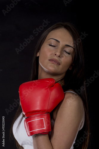 Photos Long dark hair girl on kick box training with red gloves on her hands