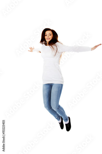 Happy jumping beautiful young woman