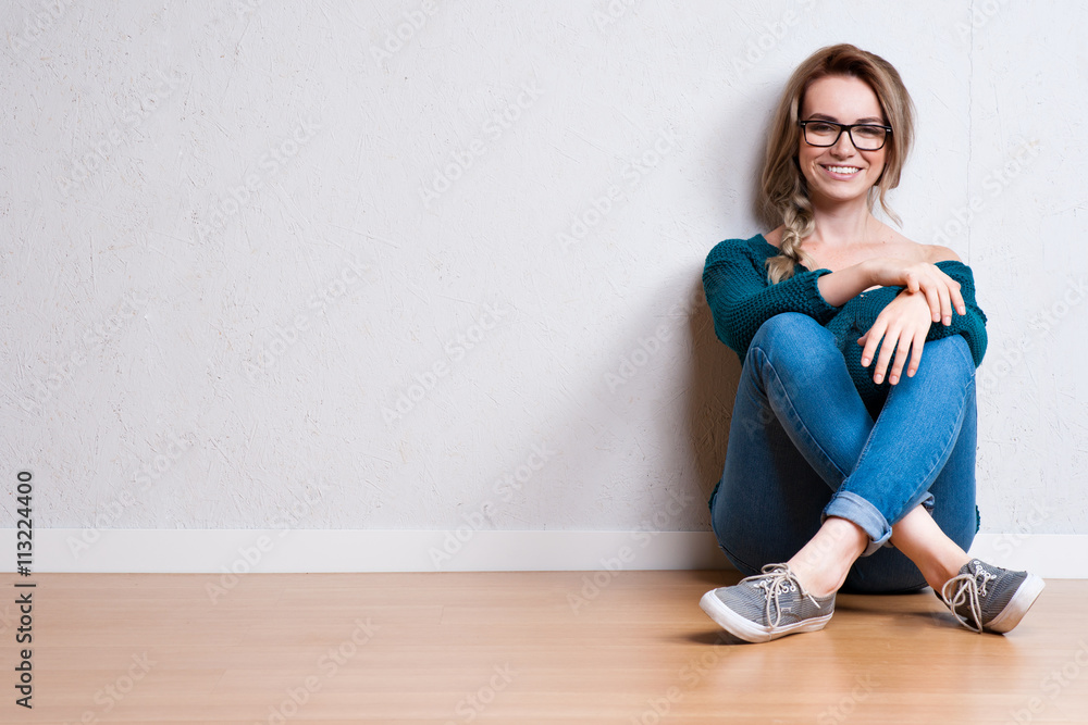 Young blonde woman relaxing on floor at home Young blonde woman relaxing on floor at home