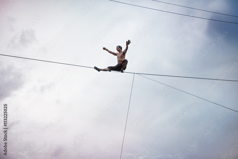 Man sitting on rope Man sitting on rope