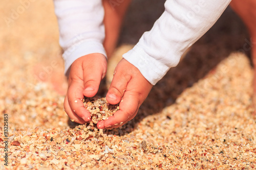 children's hands in the sand