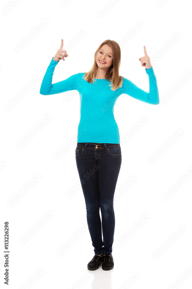 Young woman pointing up with both hands Young woman pointing up with both hands