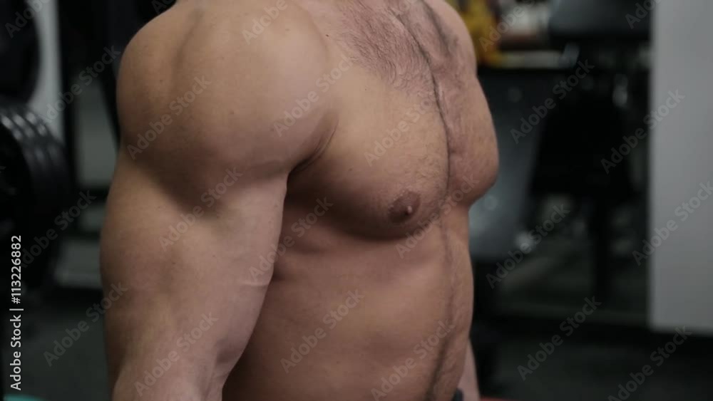 Hands of bodybuilder working with weights in the gym Hands of bodybuilder working with weights in the gym