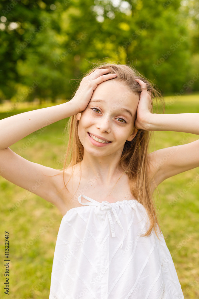 Outdoors portrait of beautiful young girl looking at you.