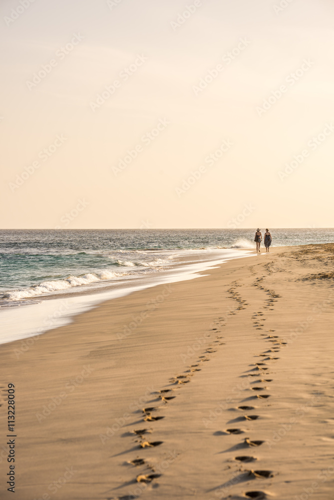 Two women walking on the beach in Sal, Cape Verde, Africa