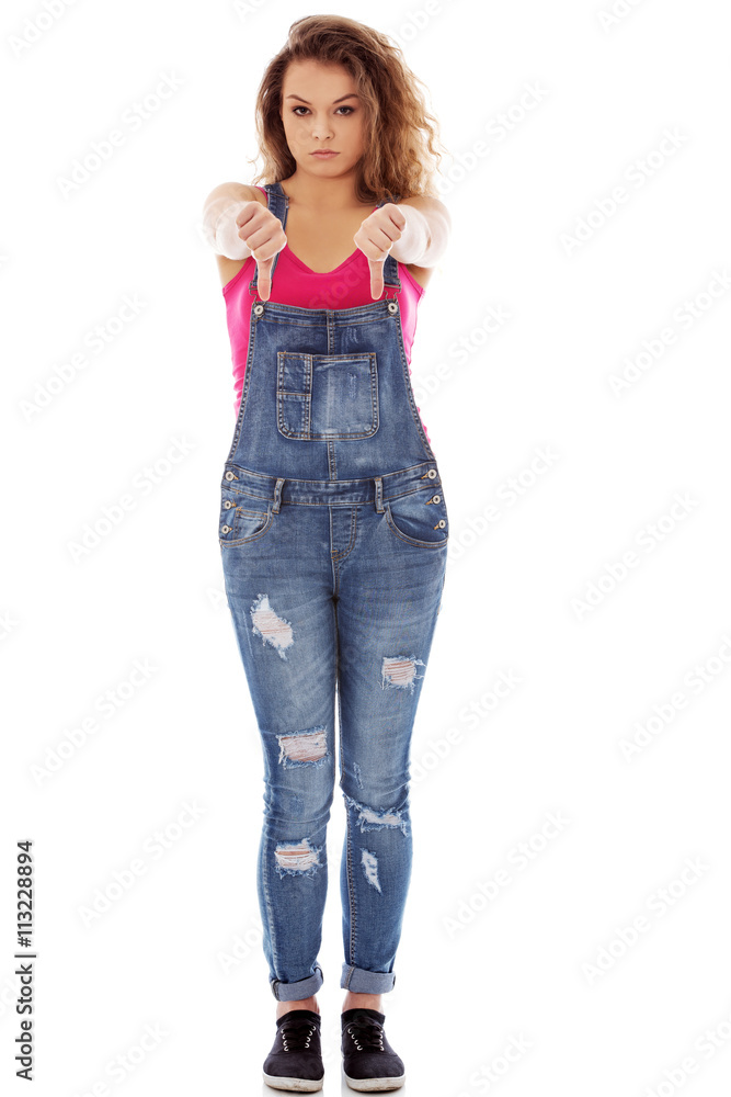Young unhappy woman with thumbs down Young unhappy woman with thumbs down