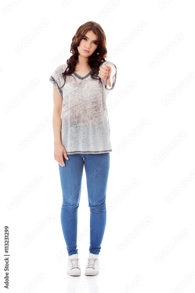 Unhappy young woman with thumbs down Unhappy young woman with thumbs down