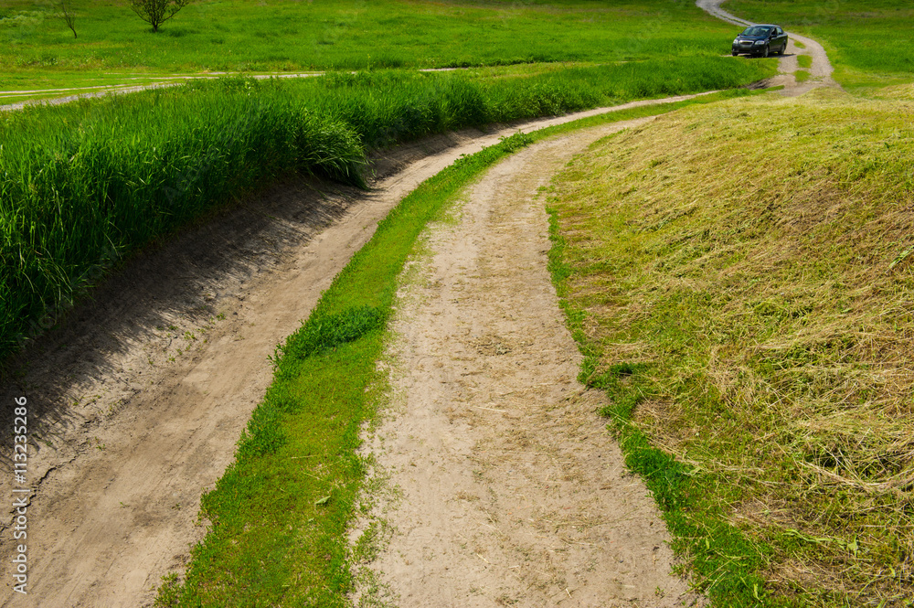 dirt road in the field and the car dirt road in the field and the car