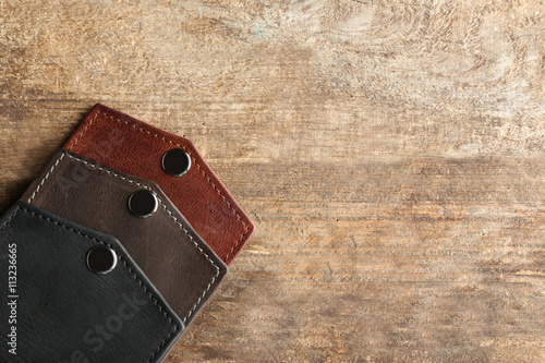 Few leather wallets on wood...