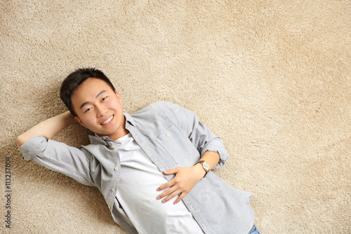 Handsome man lying on floor