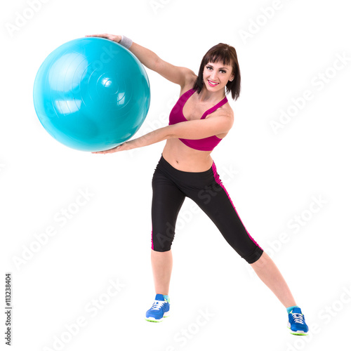 Young smiling woman makes exercise with fitball