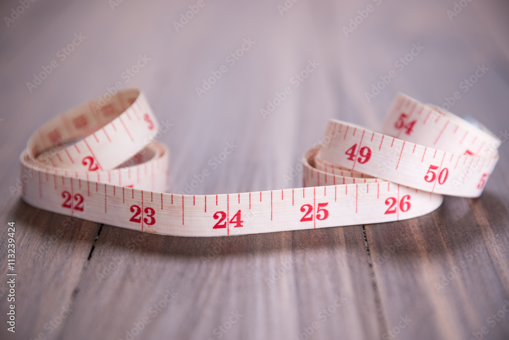 white measuring tape on wood background focus on 24 inch white measuring tape on wood background focus on 24 inch