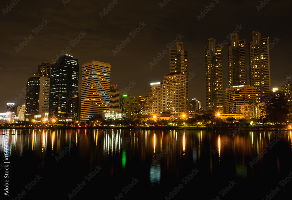Fototapeta premium Night Cityscape Lighting office building at Benchakitti Park, Ba