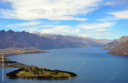 Scenic view of Queenstown and surrounding rugged mountain range (The Remarkables) on the shores of the glacial Lake Wakatipu, New Zealand