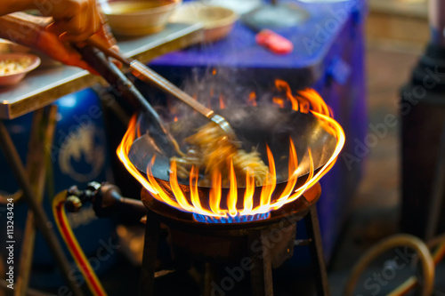 Photography Close up movement the hand a man worker Pad Thai in street chinatown or Yaowarat