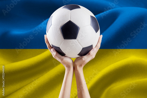 Ball on the hands with flag of Ukraine